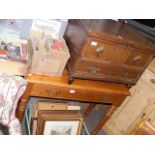 An oak blanket box with panelled front and drawer