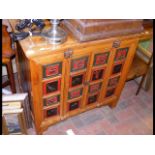 An Oriental carved cabinet with decorative panels