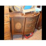 An Edwardian inlaid serpentine sideboard with thre