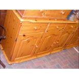 A Scandinavian Redwood Pine side cabinet with thre