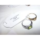 A ladies green stone dress ring and one other