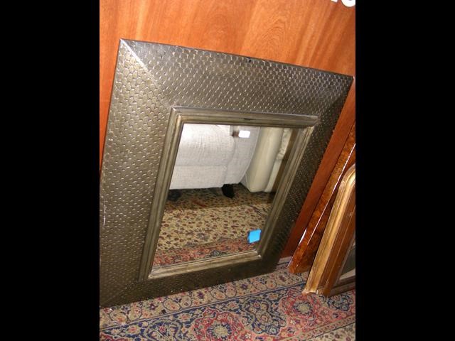 A large framed wall mirror with shell mosaic decor