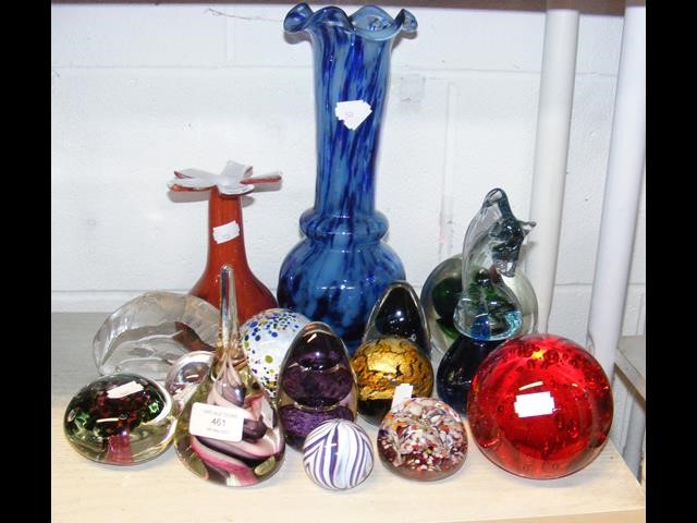 A cluster of glass paperweights and vases