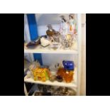 Two shelves of assorted collectables, including a