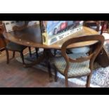 A 19th century oval mahogany dining table with cro
