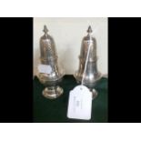 A pair of silver salt and pepper pots -12.5cm high