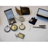 A collection of pocket watches and a silver founta