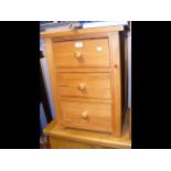 A bedside chest of three drawers