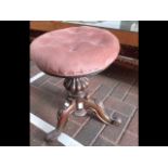 A Victorian revolving rosewood piano stool