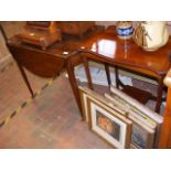 A circular drop leaf occasional table with cross b