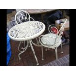 A decorative metal circular garden table and two m