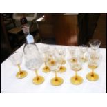 A glass decanter and fifteen glasses of varyin