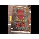 A Middle Eastern prayer rug - 140cm x 80cm