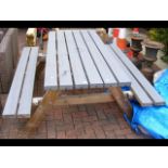 A grey coloured picnic bench