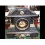 A decorative Victorian slate mantel clock with vis