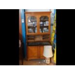 A late 19th century oak secretaire bookcase with g