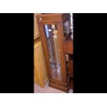 A mahogany display cabinet with four glass shelves