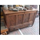An antique oak paneled mule chest - 130cms