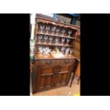 An antique style oak cottage dresser, drawers and