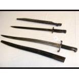 An antique long sword bayonet with leather scabbar