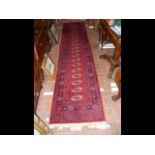 A Middle Eastern style runner with geometric borde