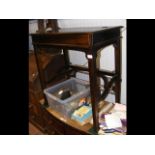 A mahogany writing desk with sliding action