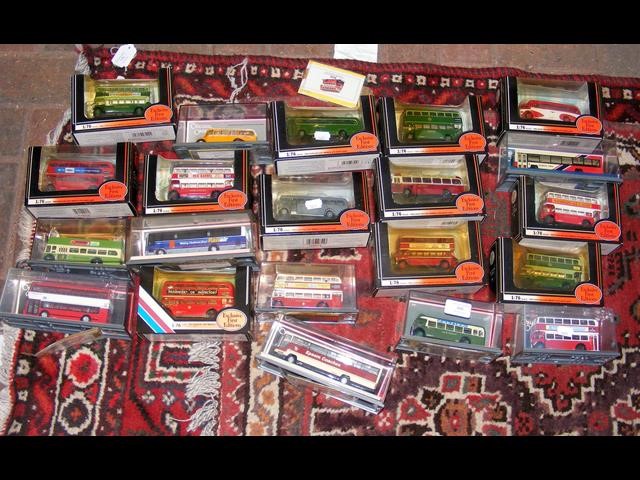 A selection of 21 boxed die cast model busses and