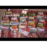 A selection of 21 boxed die cast model busses and