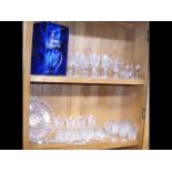 An assortment of Waterford cut crystal glass including others – on two shelves