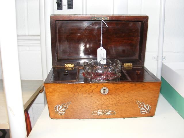 An antique tea caddy with inlaid mother-of-pearl