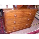 A chest of drawers with two short and two long gra