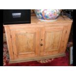 A stripped pine side cabinet - width 116cms