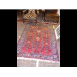 A Middle Eastern rug with red ground and geometric