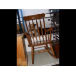 An oak slat back rocking chair