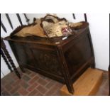 A period oak panelled coffer with carved front