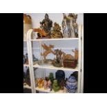 Three shelves of oriental themed collectables and