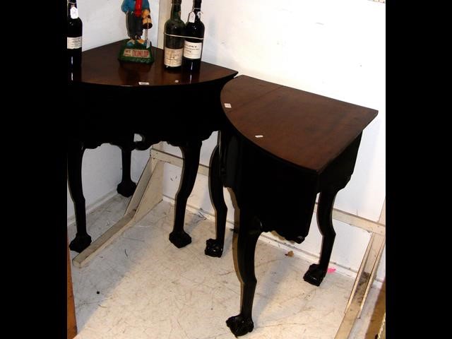 A pair of Victorian corner tables on carved cabrio