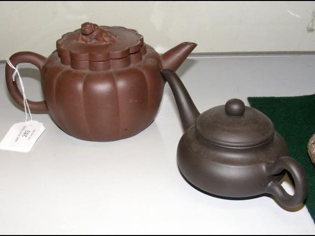 An Oriental terracotta teapot and one other