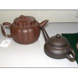 An Oriental terracotta teapot and one other