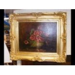 An oil on canvas still life of flowers in gilt fra