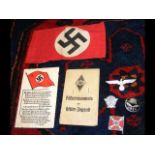 A Nazi armband together with various badges