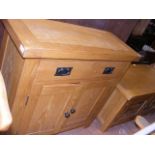 A modern oak sideboard with one drawer and two swi