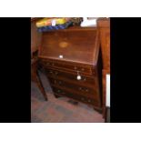 A mahogany bureau with cross banding detail