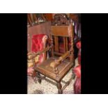 A wide seated antique oak armchair on barley twist
