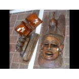 A pair of wooden bookends, carved mask