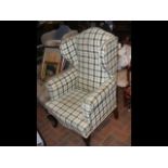 A Georgian style wing easy chair in green checkere