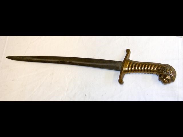 An antique short sword with stylized brass grip an