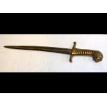 An antique short sword with stylized brass grip an