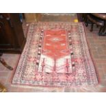 An antique Middle Eastern rug with geometric borde