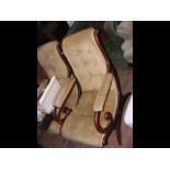 An antique x-frame button back easy chair